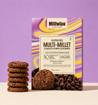 A box of Millwize Gluten Free Multi-Millet Choco Chips Cookies stands on a light beige surface against a lavender-purple background, with several chocolate chip cookies stacked beside it and loose cookies/chips shown at the base.